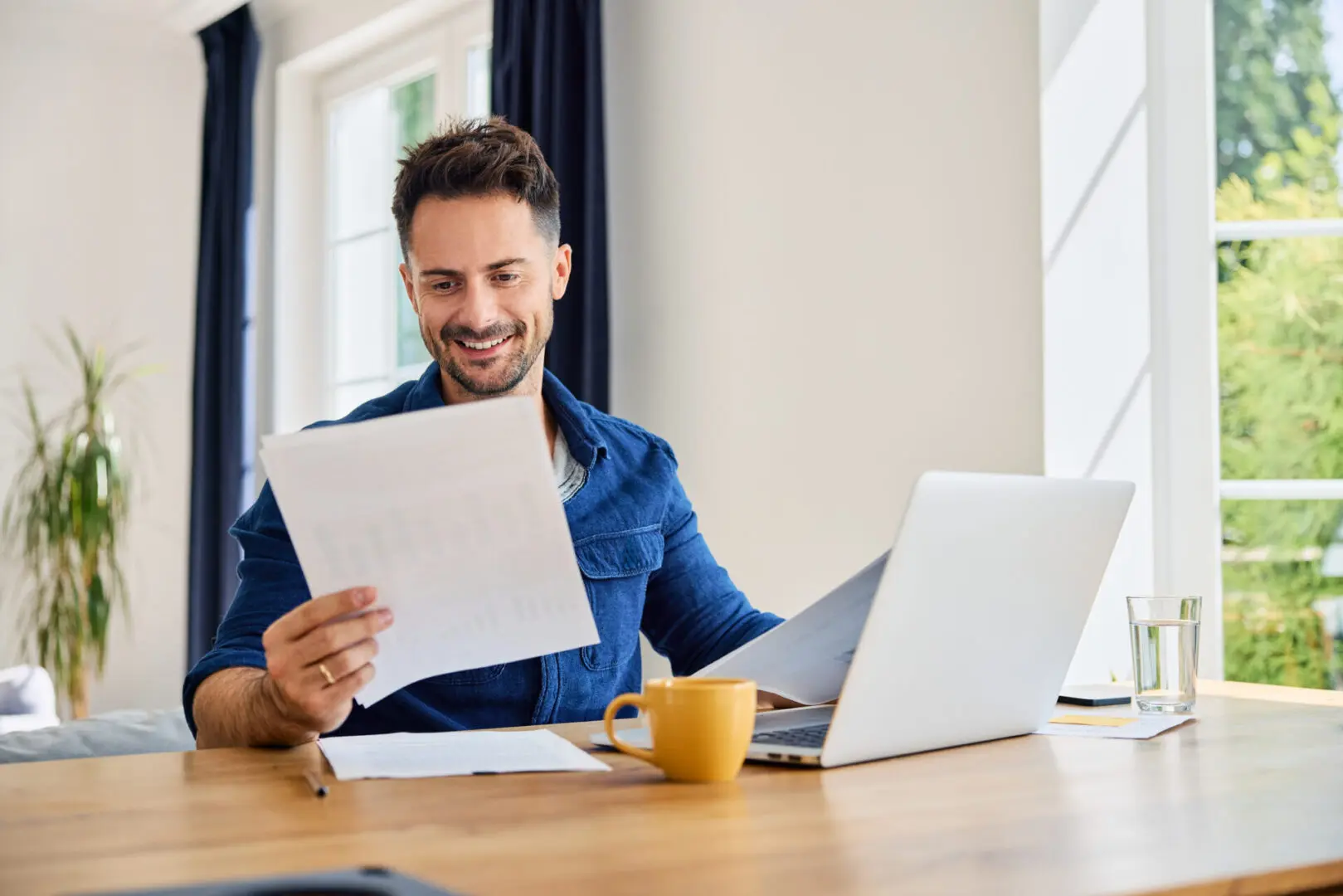 Man working at desk with laptop.