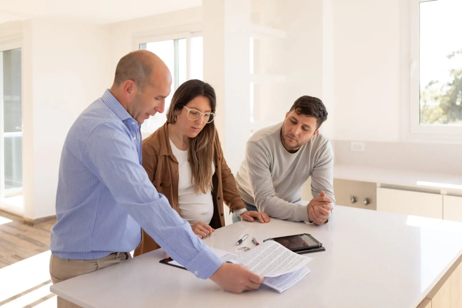 Couple reviewing documents with real estate agent